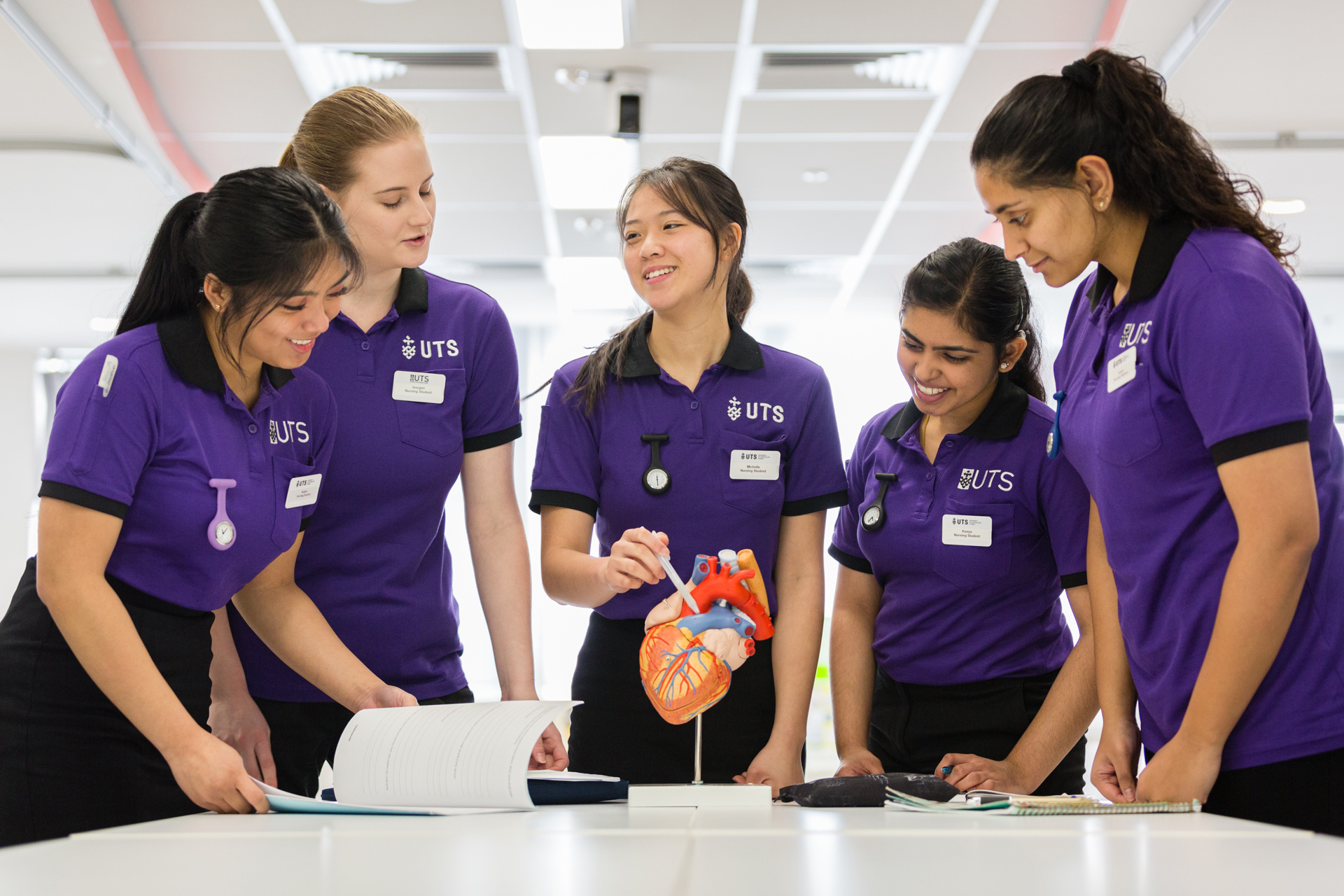 Group of UTS nursing students looking at a model of a heart.