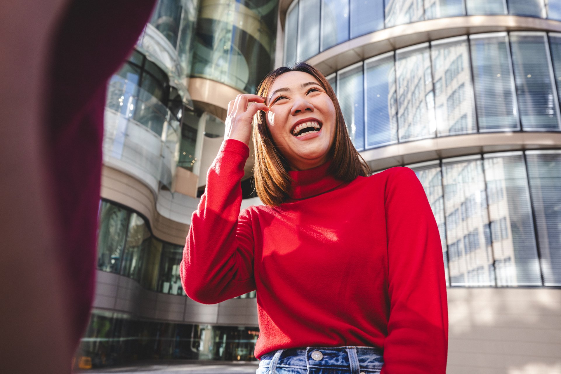 Female student in red top smiling in front of UTS Central.