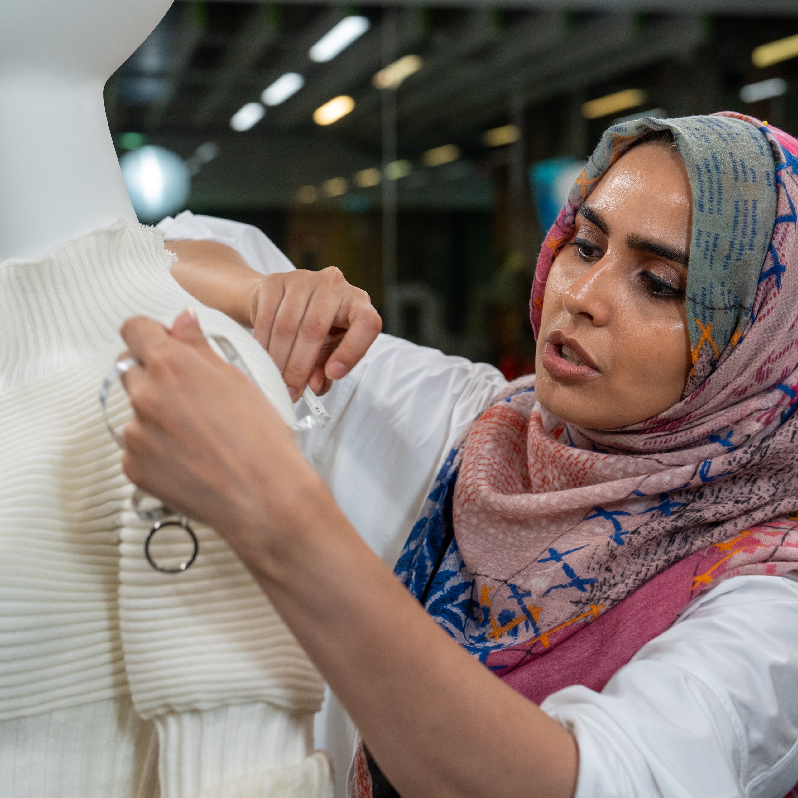 Wajiha Pervez fits a model with her garment designed and created using AI and advanced tech